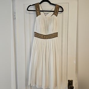 White dress with gold beading. Attached with tags